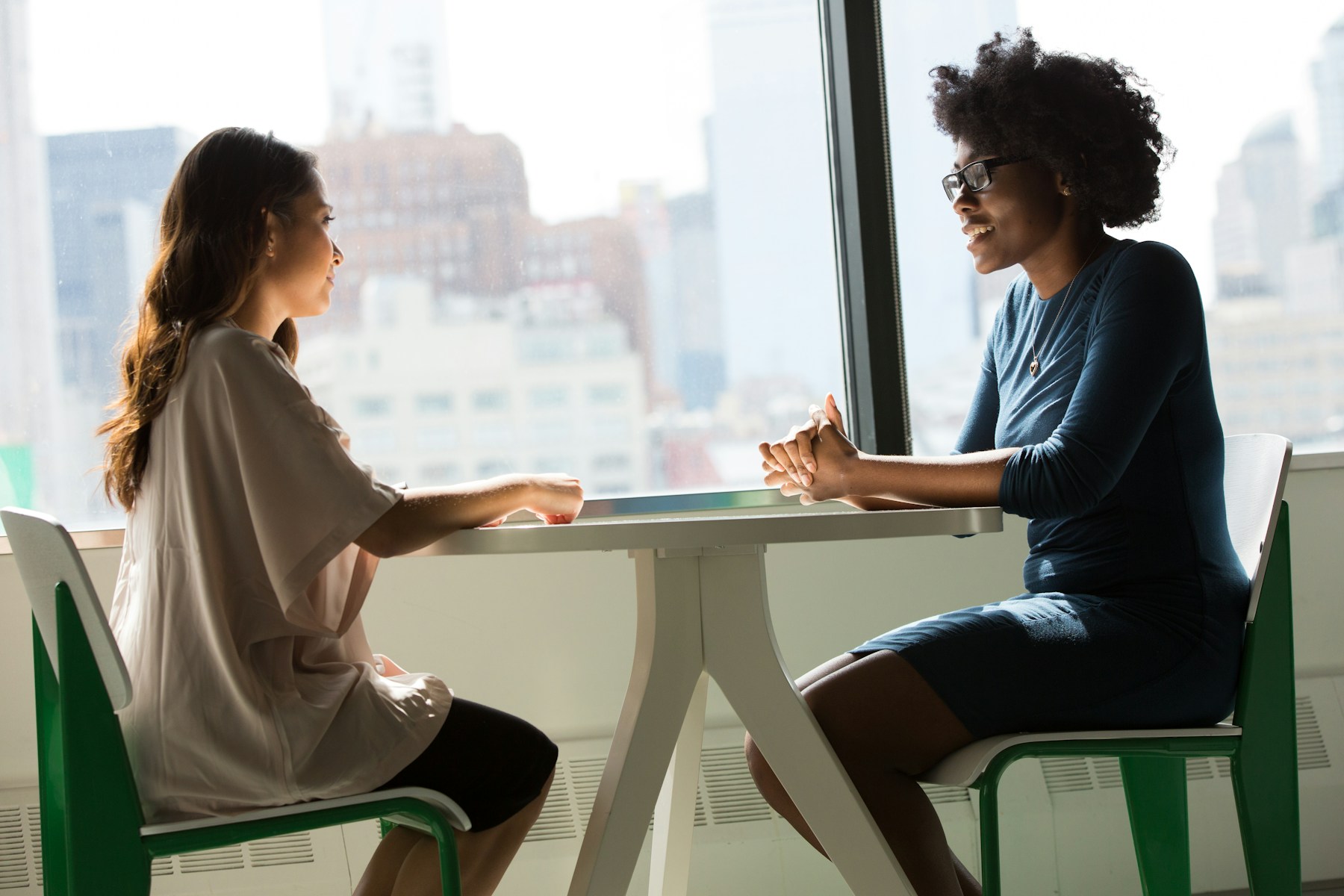 Two professionals in a one-to-one conversation