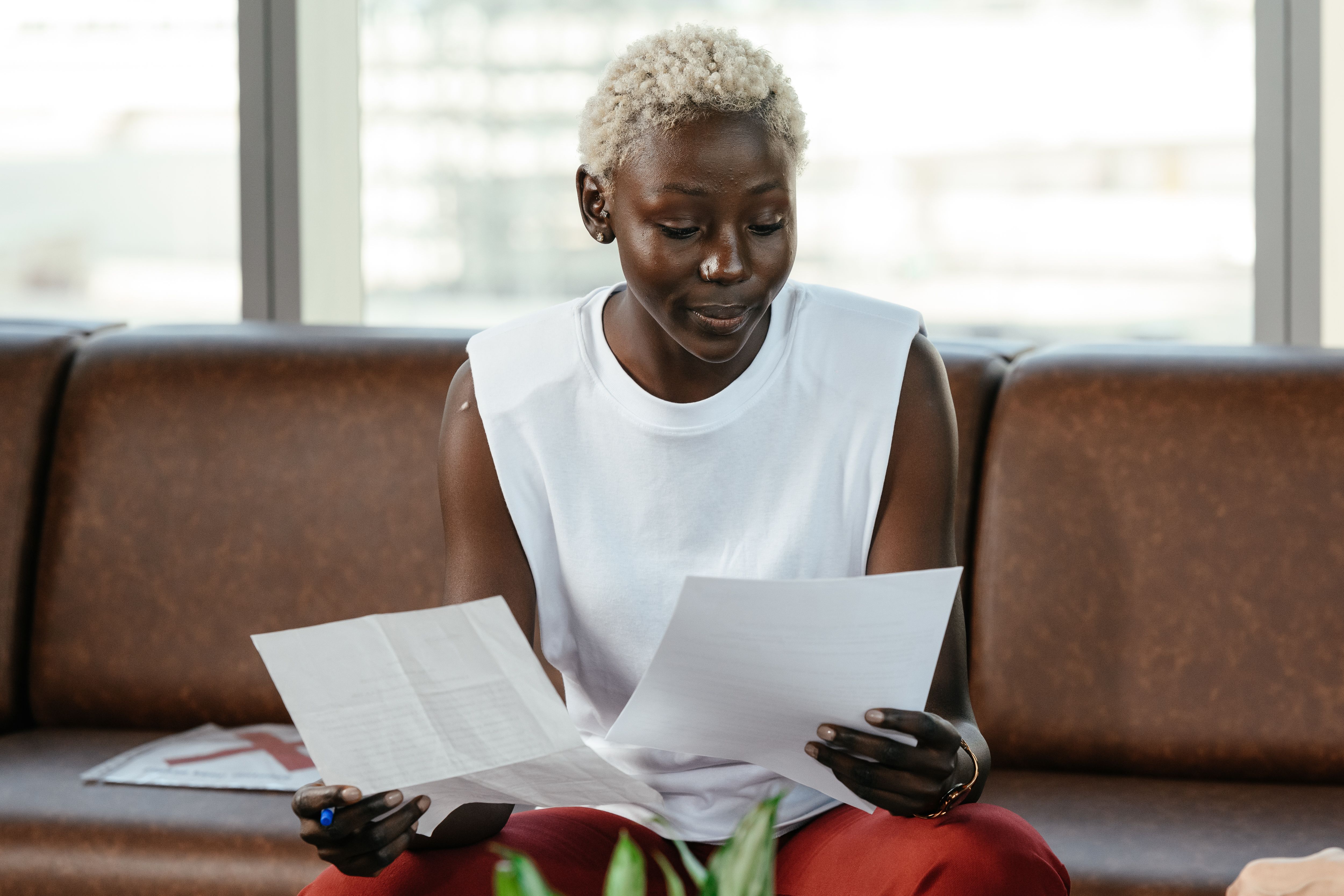A Black professional carefully reviewing documents